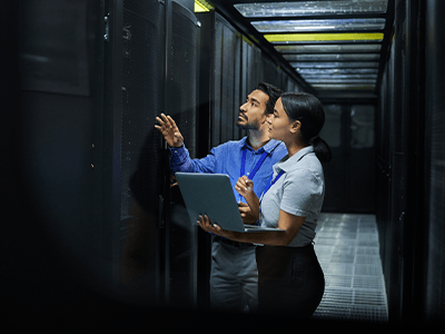 Professionals inspecting network infrastructure in a data center, emphasizing advanced network cabling installation and system performance.