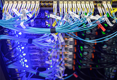 Network rack with organized fiber optic cabling, showcasing advanced installation techniques for data centers, emphasizing high-speed connectivity and redundancy.