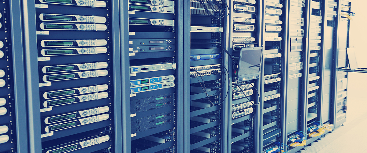 Data center network hardware with multiple servers and equipment racks, illustrating advanced technology and infrastructure for high-speed data transfer and reliable network cabling services.